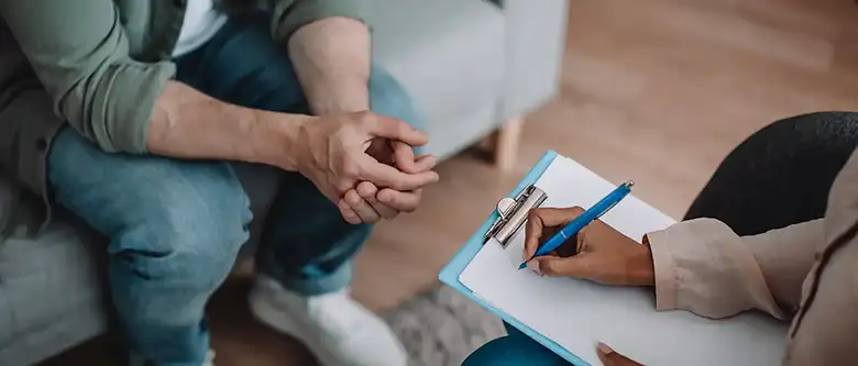 therapist writing a prescription for patient