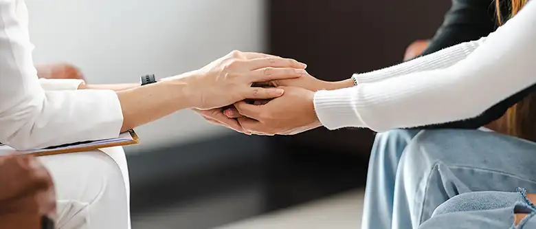 people holding hands during psychotherapy