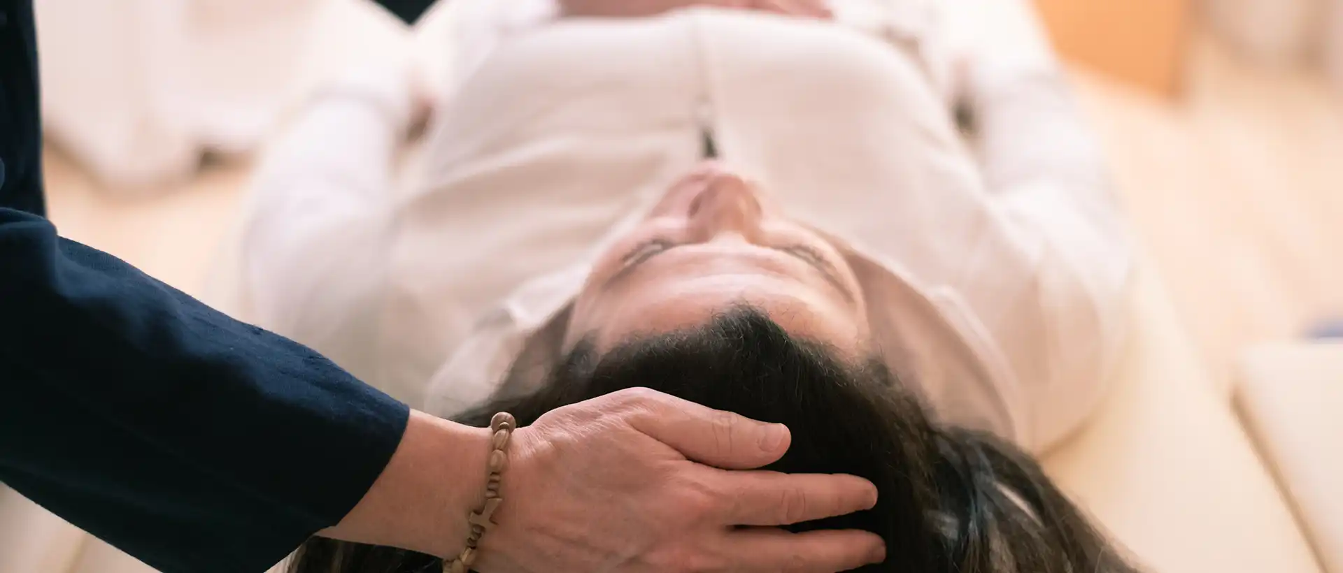 Therapist puts hand on patients head
