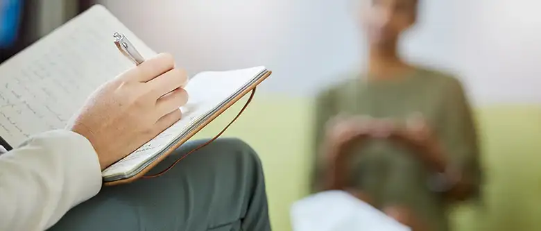 psychologist taking note during therapy