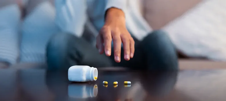 man reaching for medication