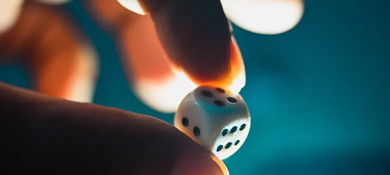 person holding dice to gamble
